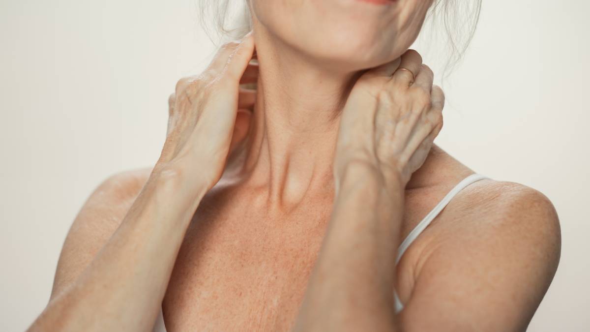 woman checking for neck bands with hands to neck